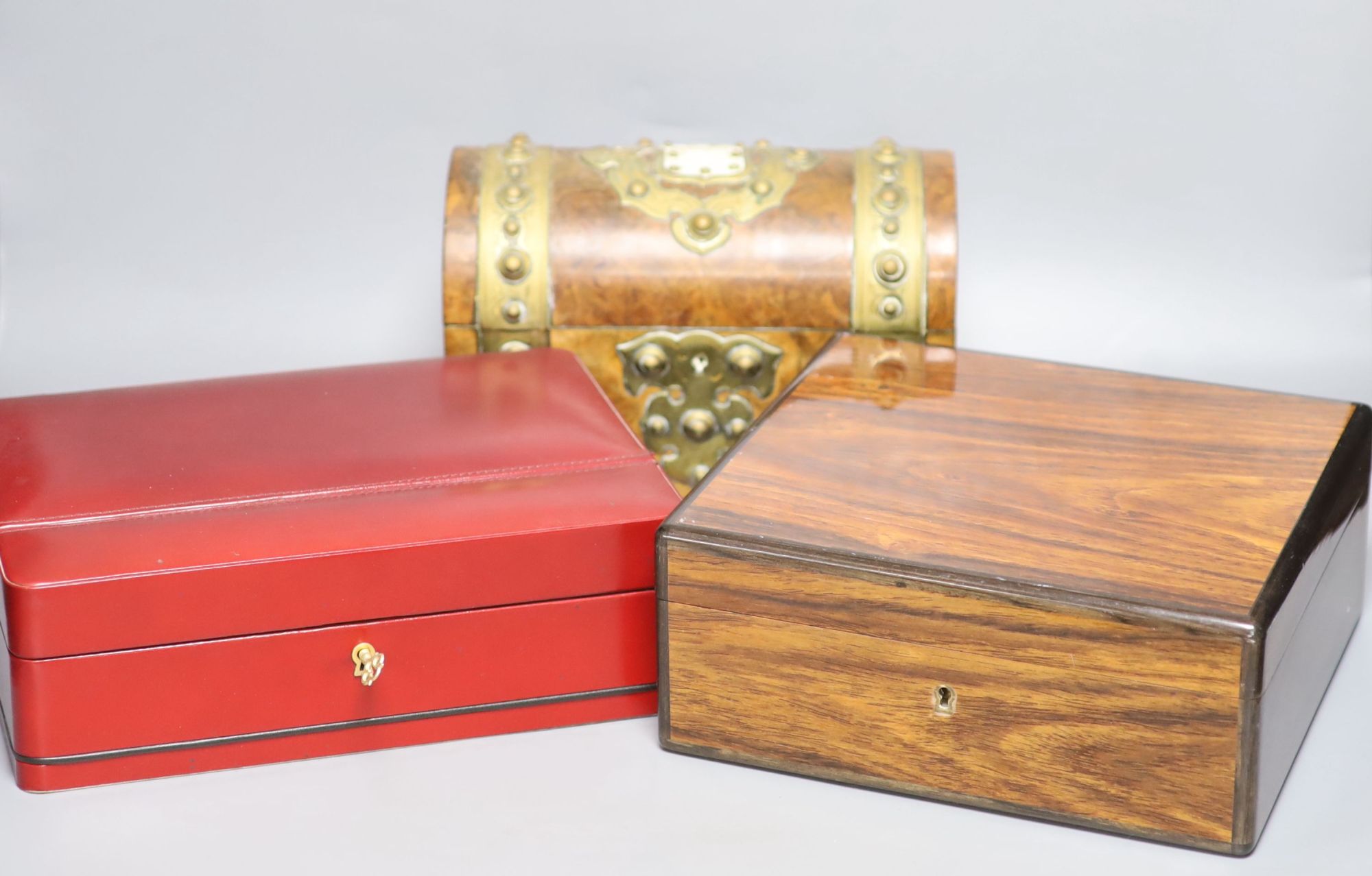 A Garrard rosewood and brass bound dome-topped box, a red leather humidor and a mahogany jewellery box